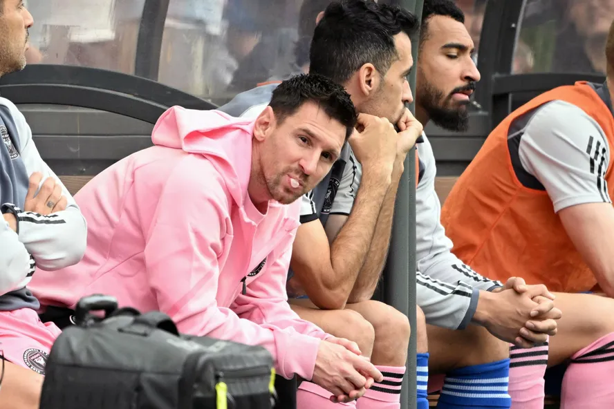105783084 miamis argentine forward lionel messi blows gum while looking on from the bench durin