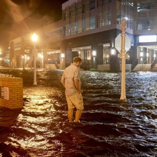 108759746 fort myers beach florida october 09 brandon marlow walks through surge waters floodi