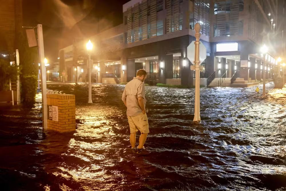 108759746 fort myers beach florida october 09 brandon marlow walks through surge waters floodi