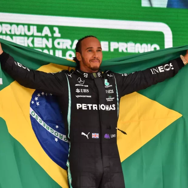 96196989 mercedes british driver lewis hamilton celebrates on the podium after winning brazils for