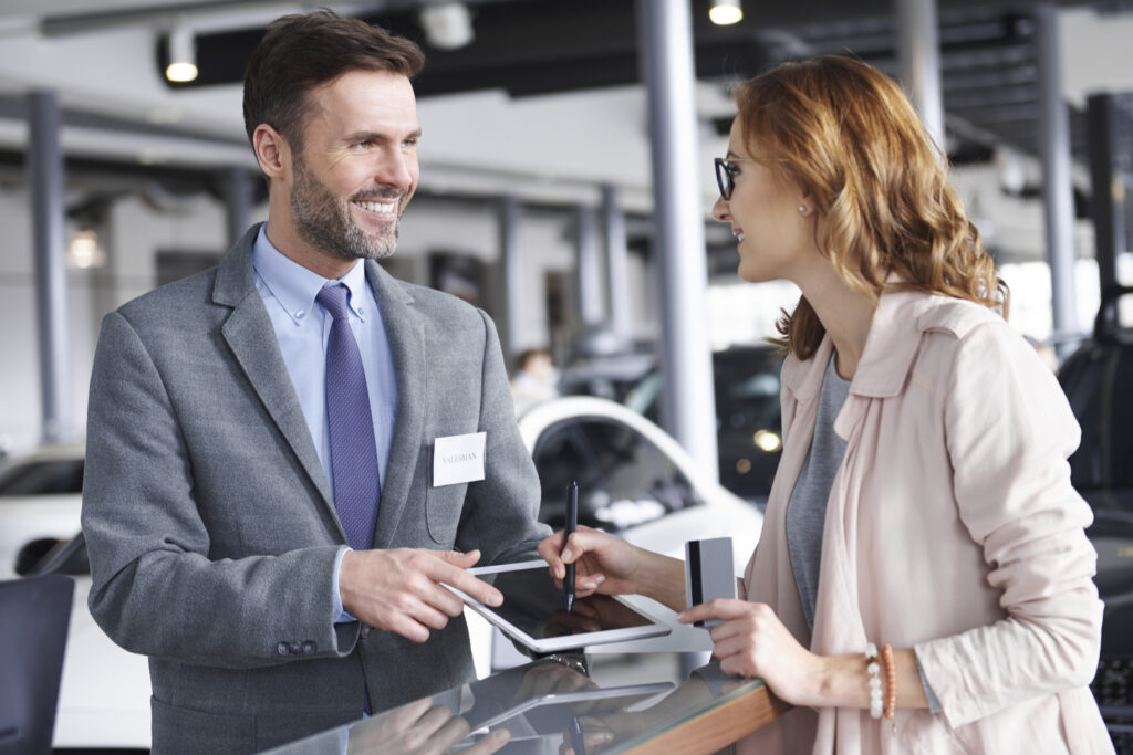 waist up of salesman with female customer