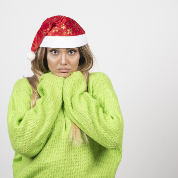 young woman posing in santa claus red hat