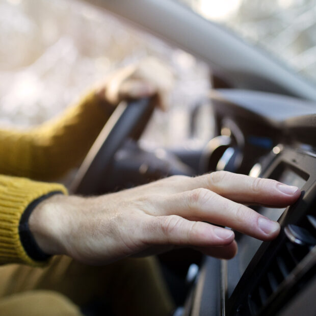 close up hand holding steering wheel