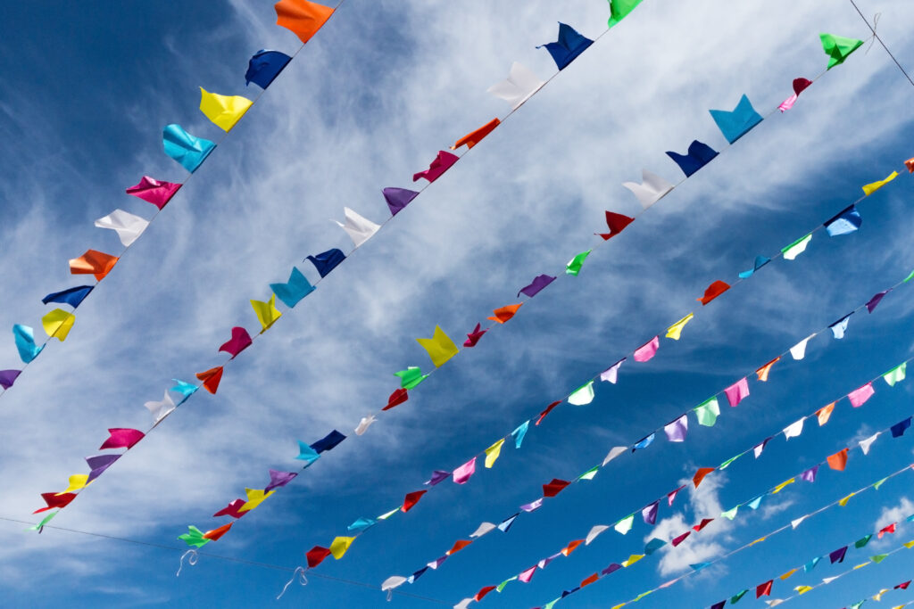 small cute colorful flags on rope hanging outside for holiday wi