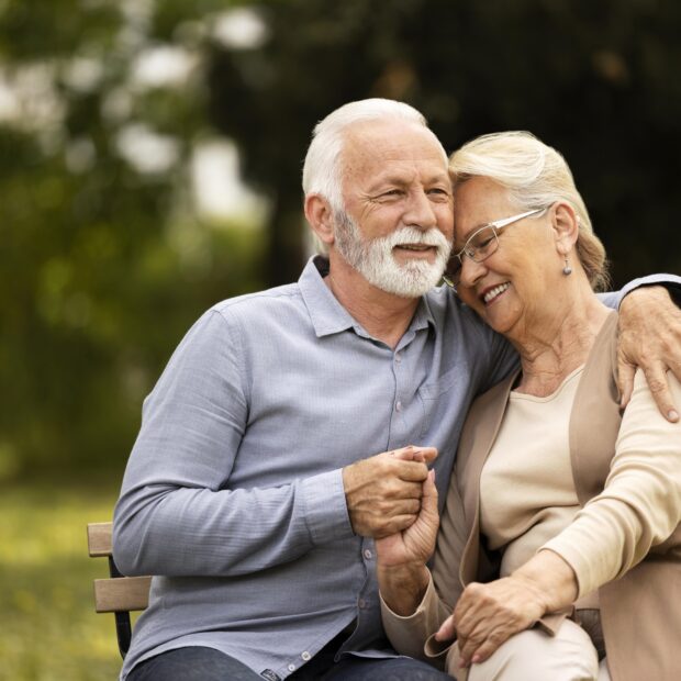 medium shot smiley senior couple sitting