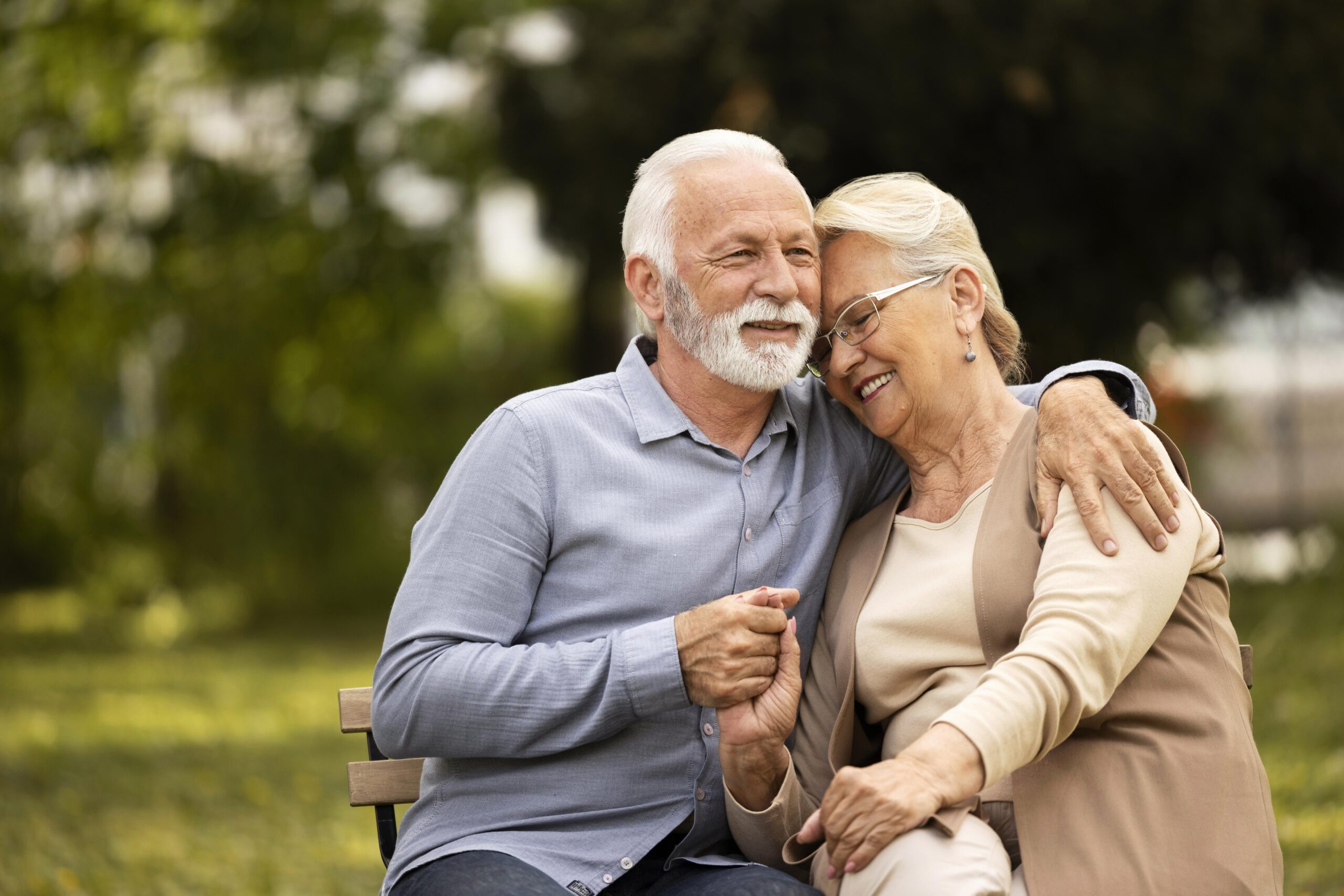 medium shot smiley senior couple sitting