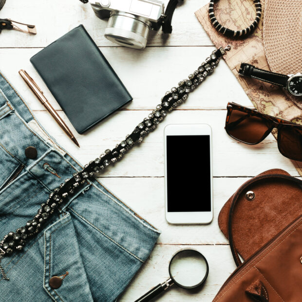 top view accessoires to travel with women clothing concept.white