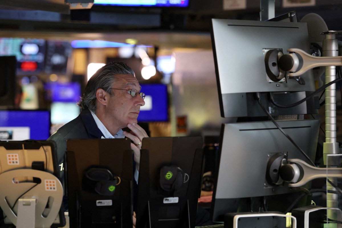 traders work on the floor of the new york stock exchange (nyse) at the opening bell ahead of fed's latest rate decision
