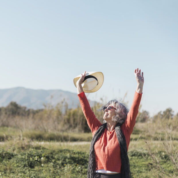 medium shot woman with sunglasses hat