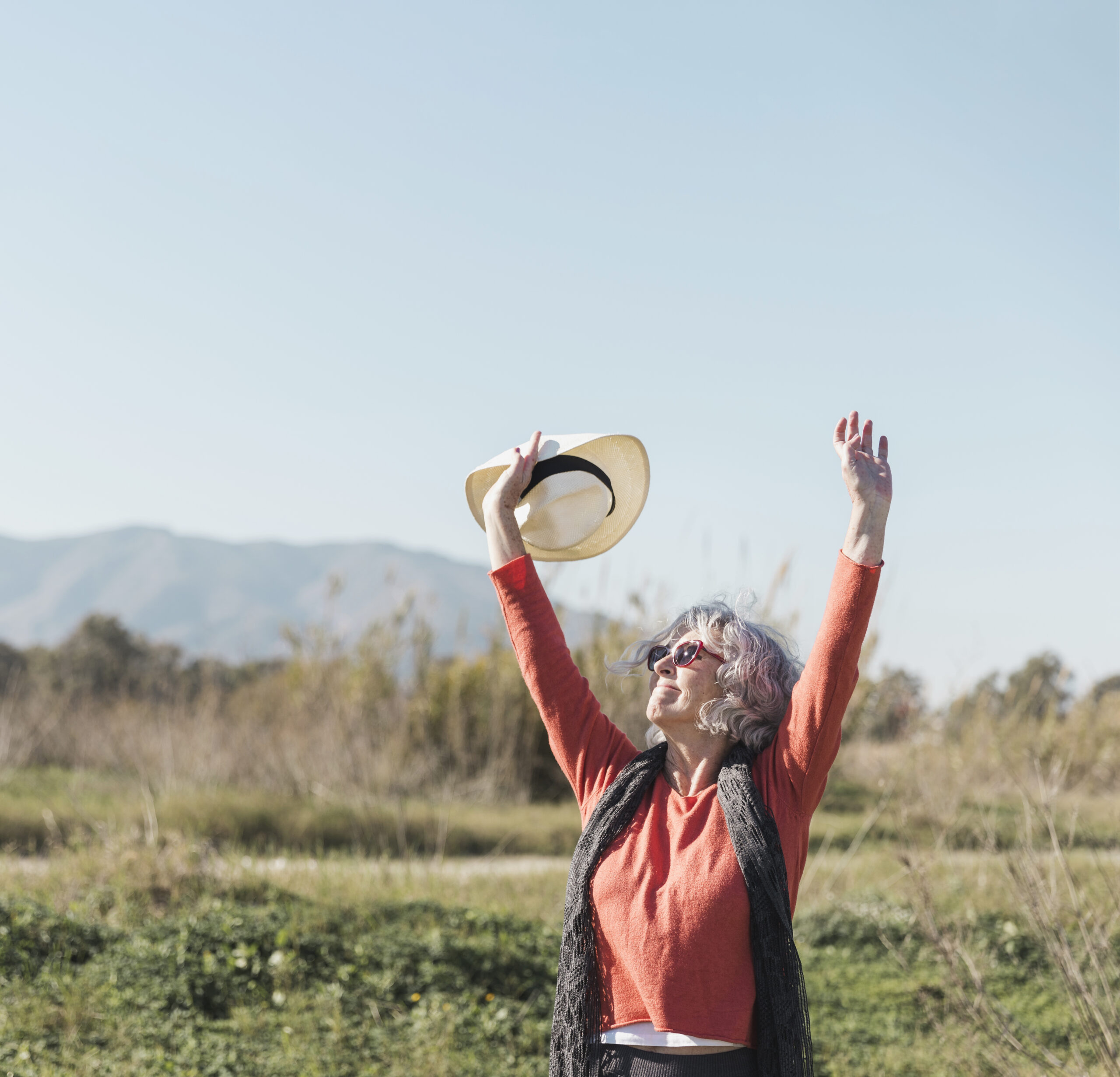 medium shot woman with sunglasses hat