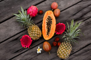 composicao com frutas tropicais em superficie de madeira