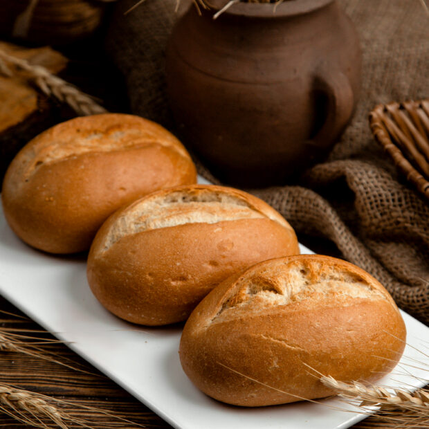loaf of brown bread on a wooden table