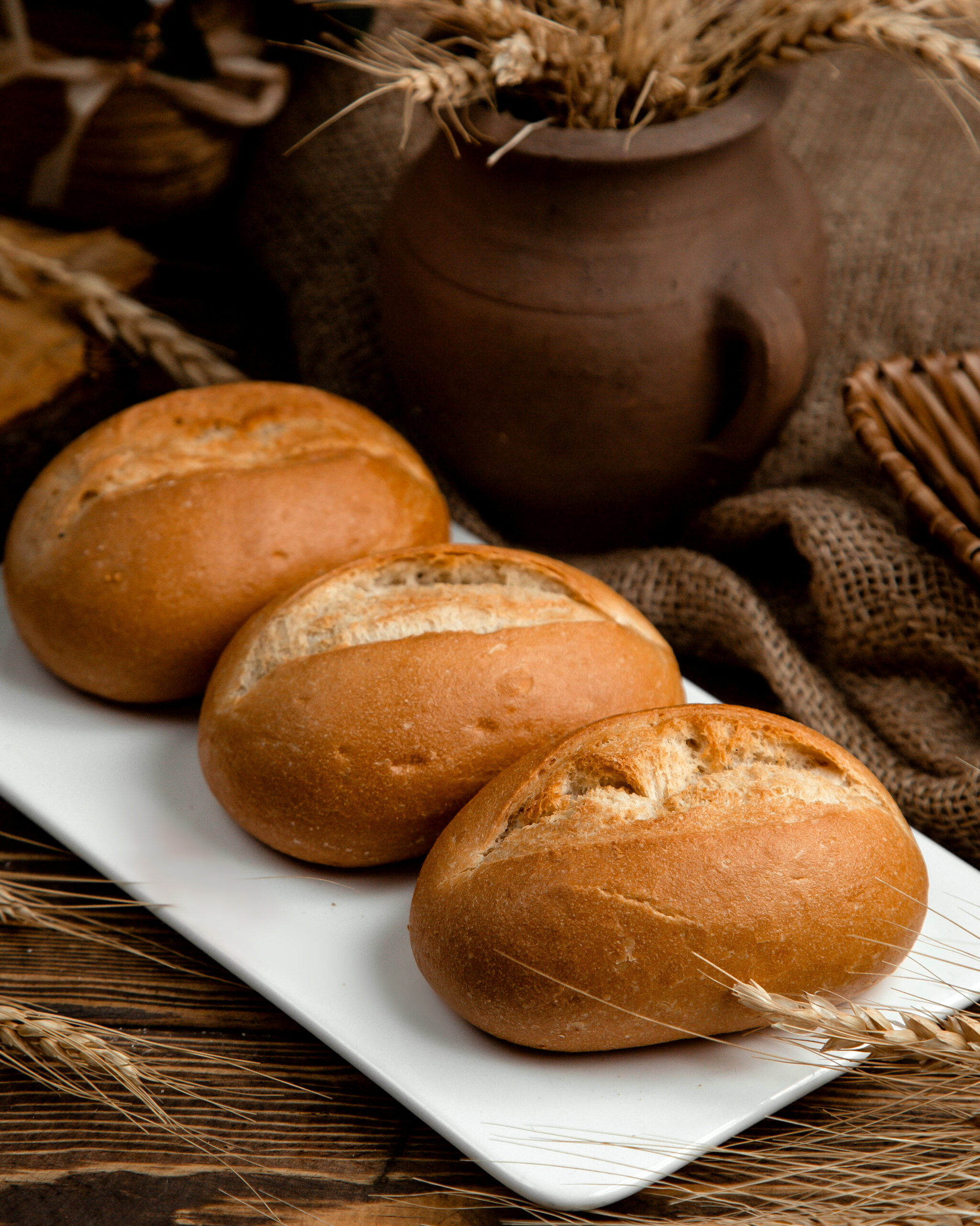 loaf of brown bread on a wooden table