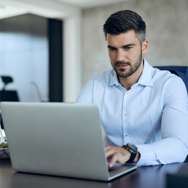 male entrepreneur using computer while working in the office.