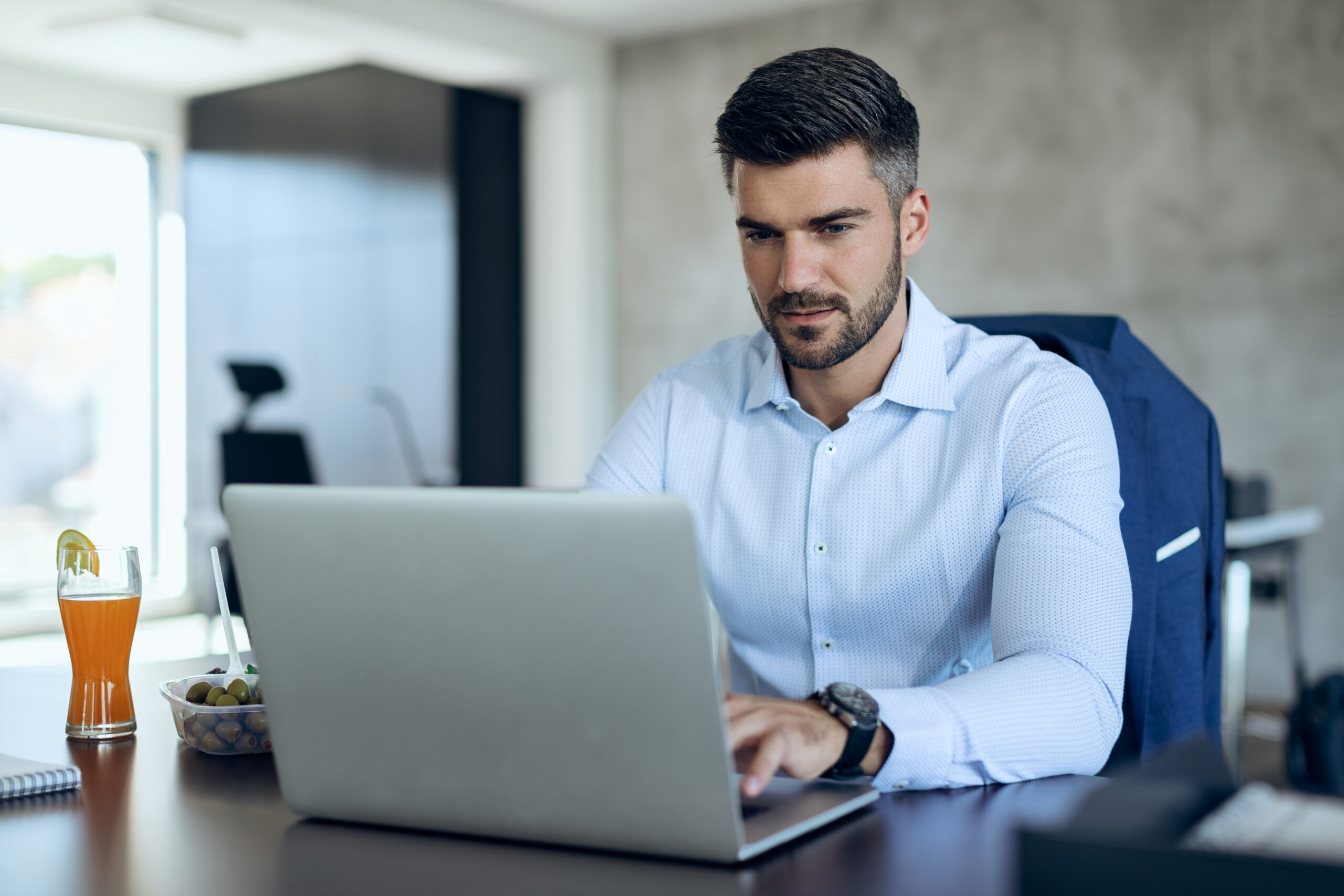 male entrepreneur using computer while working in the office.