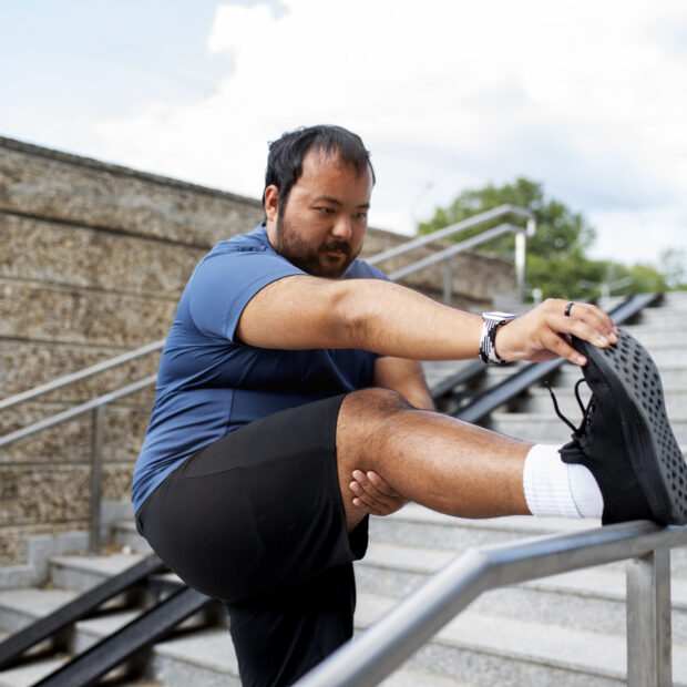overweight man exercising stairs outdoors