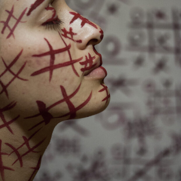 woman with red symbols painted face