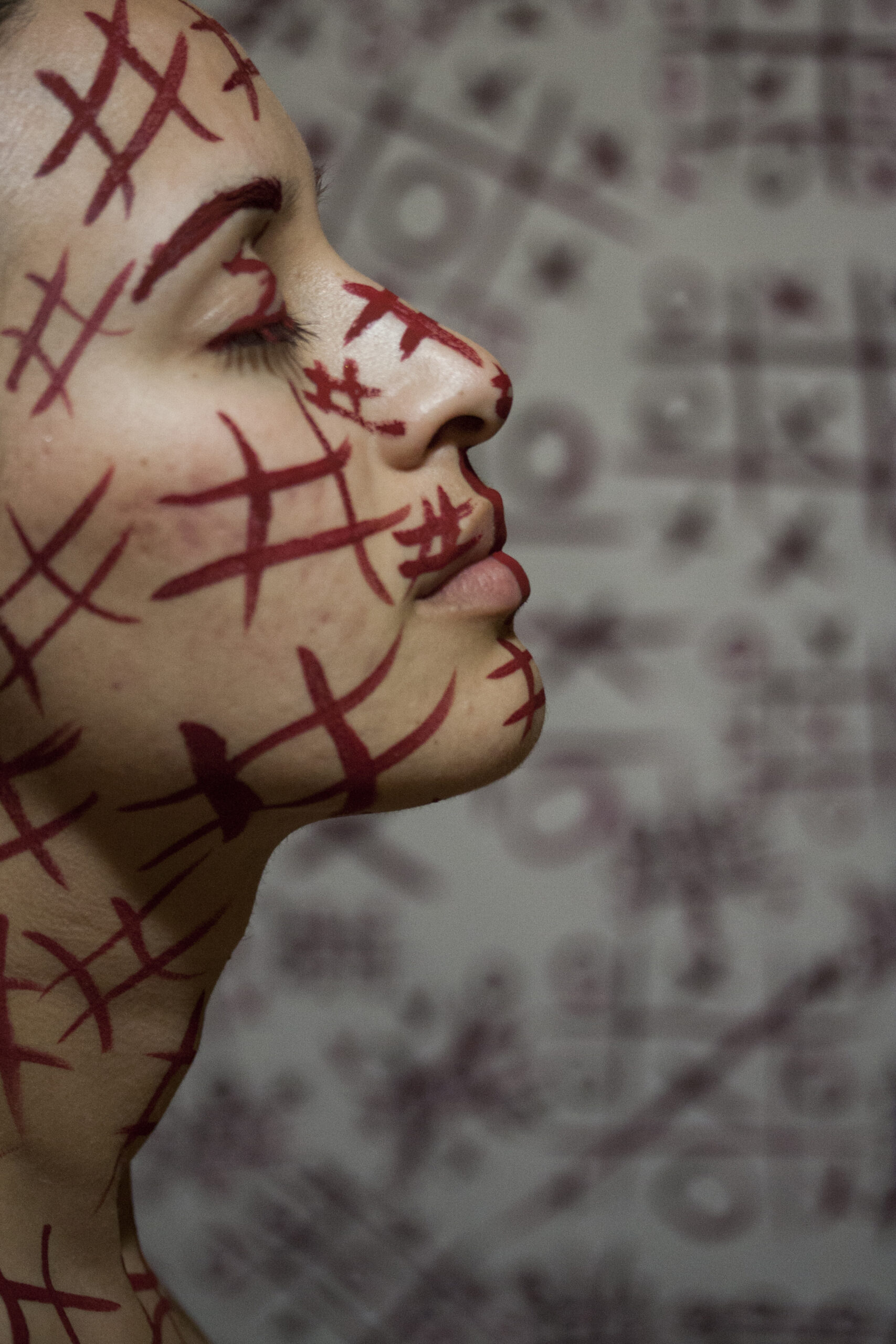 woman with red symbols painted face