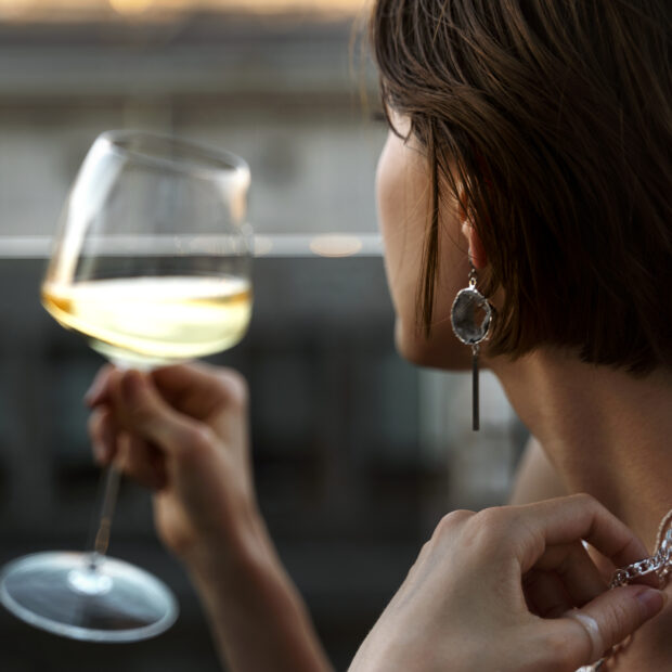 portrait rich woman drinking wine outdoors