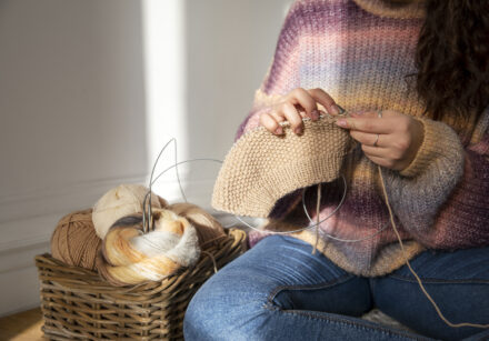 close up woman knitting floor