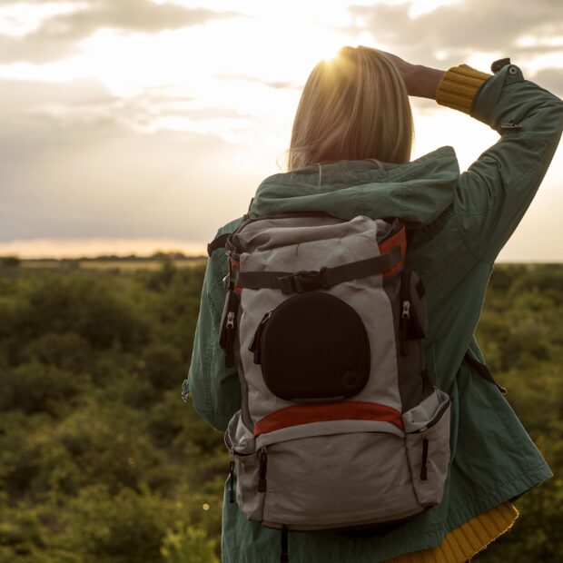 woman with backpack sunset traveling