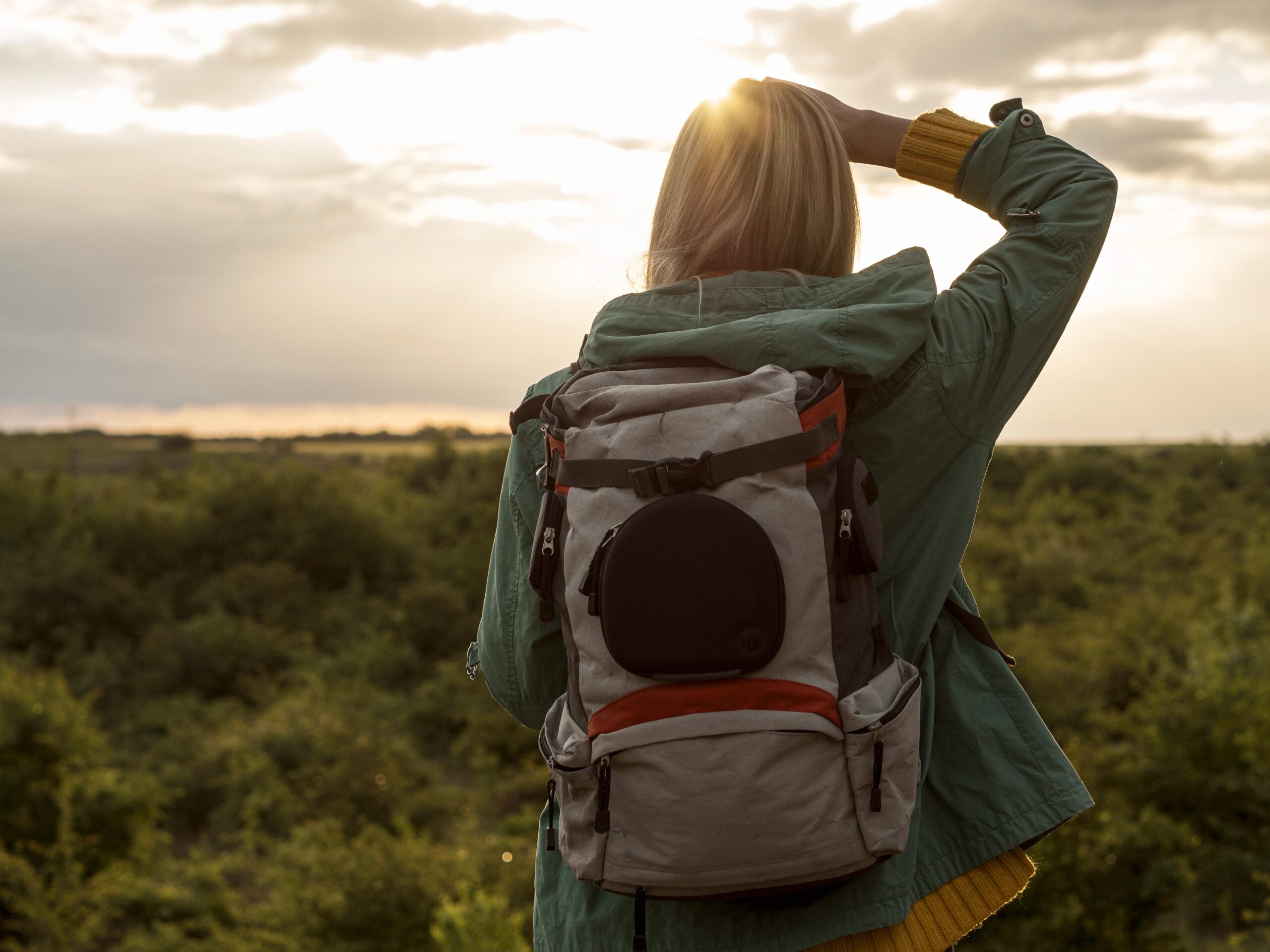woman with backpack sunset traveling