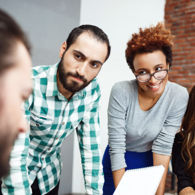 colleagues discussing new ideas at business meeting.