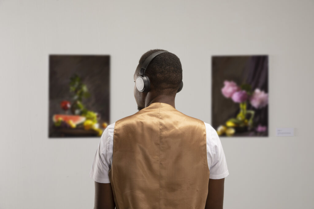 man with headphones art gallery back view