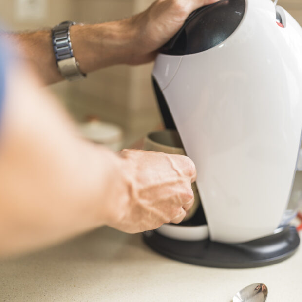 woman making coffee from capsule espresso coffee maker