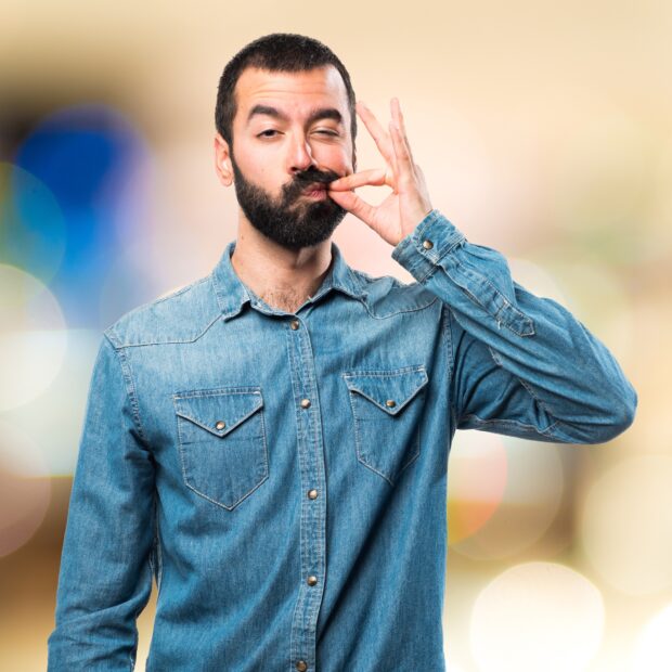 man making silence gesture