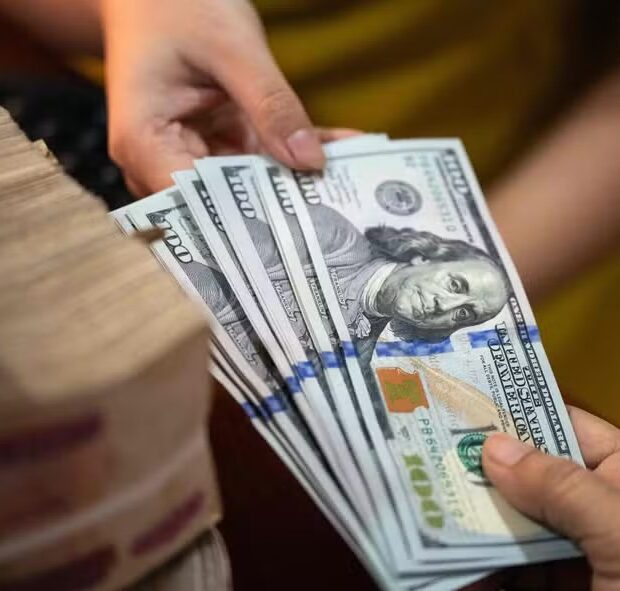 107113510 this photo illustration shows us dollar notes r next to a stack of myanmar kyat notes in y