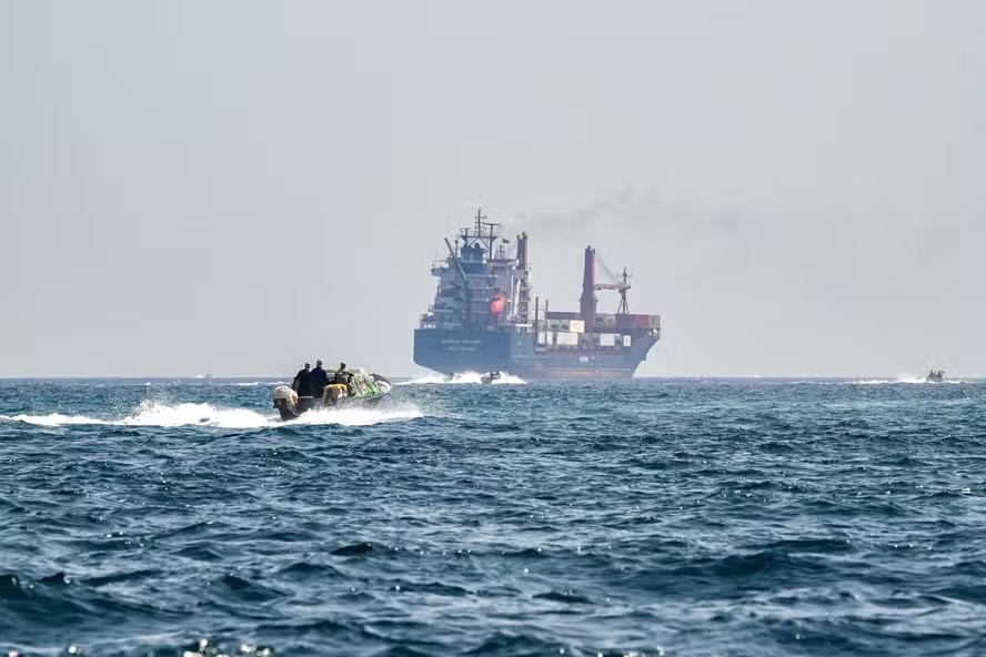 114357063 files a boat approaches the st kitts and nevis flagged container ship marsa victory while