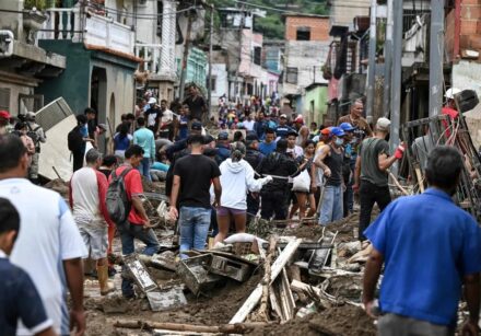 100783386 topshot residents walk among the rubble of destroyed houses washed away by a landslide d