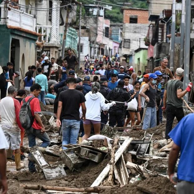 100783386 topshot residents walk among the rubble of destroyed houses washed away by a landslide d