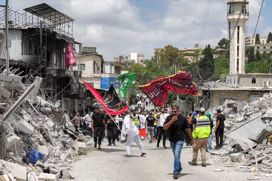 115440017 editors note graphic content shia muslim devotees march in a procession past buildings d