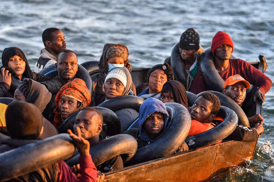 100727418 topshot migrants from sub saharan africa sit in a makeshift boat that was being used to
