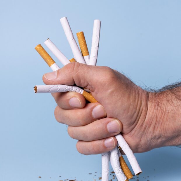 close up hand holding cigarettes