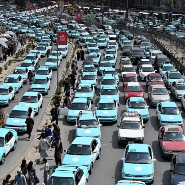 116353429 commuters riding blue taxis wait in a traffic jam in kabul on september 14 2026 taxi drive
