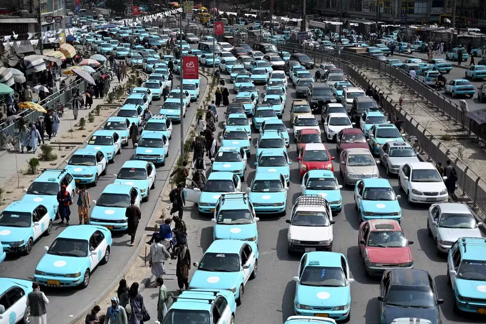 116353429 commuters riding blue taxis wait in a traffic jam in kabul on september 14 2026 taxi drive