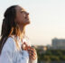 beautiful young woman smiles tender standing on the rooftop in t