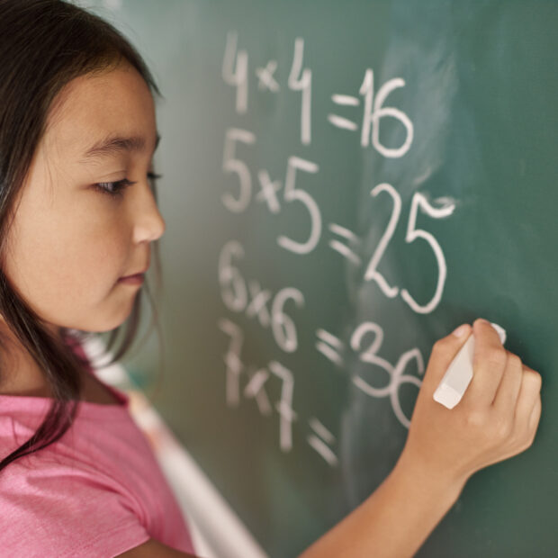 focus girl trying to solve mathematical equation
